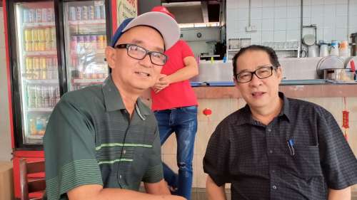 Author Don Peter seated with the late MA63 researcher and activist Zainnal Ajamain at a coffee shop in Kota Kinabalu, Sabah.