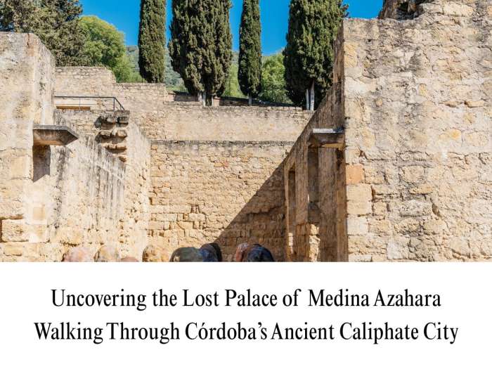High-resolution photograph showing the excavated stone masonry, ancient drainage channels, and cypress trees at the Medina Azahara archaeological complex near Córdoba, Spain.