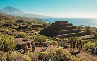 Conceptual artwork featuring the step-pyramids of Güímar, volcanic landscape, and Guanche inhabitants on Tenerife for a historical travel guide.
